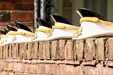 West Point Cadets Lay Their Headwear On The Edge Of The Brick.