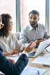 © insta_photos - Diverse executive business team group discuss project at boardroom meeting table. Multiracial team negotiating developing international corporation business plan doing analysis in office. Vertical.