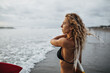 © Look! - Girl with wavy blond hair looks at sea