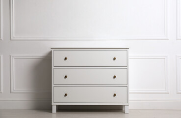 Wall Mural - Stylish chest of drawers near white wall indoors