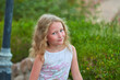 © Alexey Lesik - portrait of baby girl on background of greenery. Girl posing against background of summer greenery. Portrait of little girl