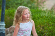 © Alexey Lesik - portrait of baby girl on background of greenery. Girl posing against background of summer greenery. Portrait of little girl