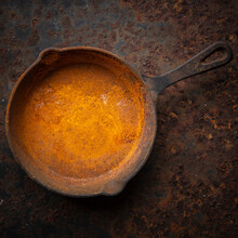 Rusty Cast Iron Skillet On A Dirty Rust Metal Plate Texture Background In Square Ratio, Top View