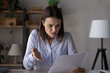 © fizkes - Unhappy millennial Caucasian woman feel distressed upset with bad news in post paper correspondence. Mad young female frustrated confused with message in postal paperwork letter or document.