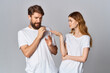 © SHOTPRIME STUDIO - cheerful young couple in white t-shirts with headphones listening to music joy friendship