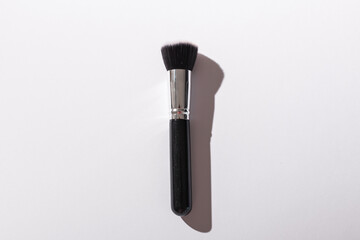 Wall Mural - Make-up brush on white background, top view. Cosmetics and beauty concept.