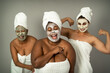 © Alessandro Biascioli - Happy multiracial women having skin care spa day - People selfcare concept