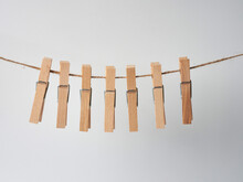 Set Of Wooden Clothes Pins On White Background