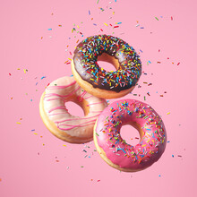 Flying Frosted Sprinkled Donuts. Set Of Multicolored Doughnuts With Sprinkles Isolate On Pink Background. 3d Rendering.