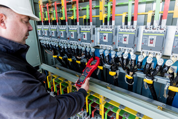 Wall Mural - checking the operating voltage levels of the solar panel switchgear compartment