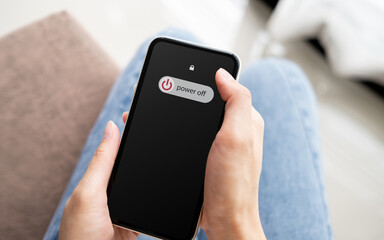 woman hand using is sliding to turn off the mobile phone to reduce power consumption. technology and