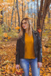 © satura_ - Cute smiley woman holding autumn leaves in fall park. Seasonal, lifestyle and leisure concept.