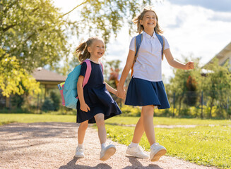 Wall Mural - Girls with backpack are going to school