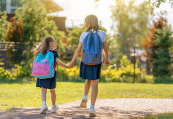 Wall Mural - Girls with backpack are going to school