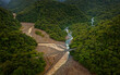Confluence of the river Rio Sucio and Rio La Hondura in National Park Braulio Carillo, clear river and dirty river confluence, bridge over the river in Costa Rica, Central America