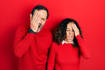 Poster - Middle age couple of hispanic woman and man hugging and standing together yawning tired covering half face, eye and mouth with hand. face hurts in pain.