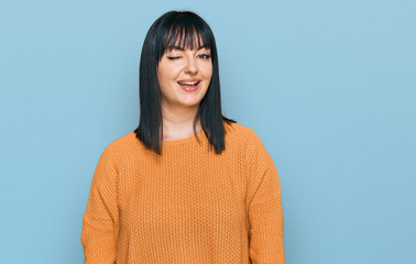 Poster - Young hispanic woman wearing casual clothes winking looking at the camera with sexy expression, cheerful and happy face.