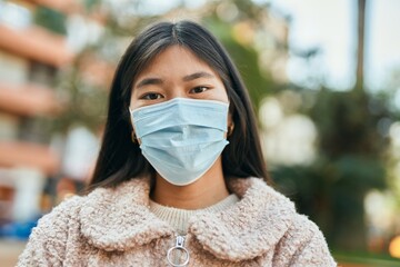 Sticker - Young asian woman wearing medical mask standing at the city.