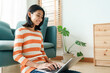© sorrapongs - Asian girl student learning online via the internet with tutor on laptop