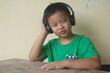 The boy listens music, sound through wireless headphones.