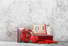 Cube Calendar With Alarm Clock And Stationery On Grunge Background