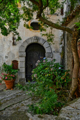  The facade of an old house in the historic center of Maratea, a medieval town in the Basilicata region, Italy.