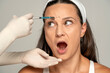 © vladimirfloyd - scared woman on a face filler injection procedure