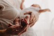 © Ananass - legs of a newborn baby in parental hands