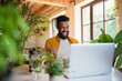 © Halfpoint - Cheerful young man with laptop working indoors, home office concept.