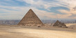 The Great Pyramid of Menkaure in the Giza, Egypt. Pyramid Complex on background Cairo city skyline with dramaric sky.