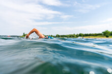 Blurred Swimmer Behind Waves In A Lake