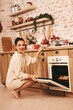 © Kateryna - cheerful, happy girl in the New Year's kitchen. preparation for the holiday of the new year.