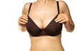 © vladimirfloyd - A woman adjusts her large breasts in the bra