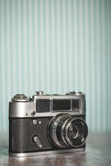 Wall Mural - Old retro camera on a wooden desk