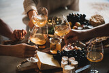 Fototapeta Kuchnia - Group of unrecognizable people celebrating holiday clinking glasses of wine