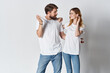 © SHOTPRIME STUDIO - cheerful young couple in white t-shirts posing fashion light background