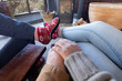 © Wavebreak Media - Happy diverse couple in living room sitting by fireplace holding hands