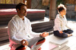 © Wavebreak Media - Diverse couple wearing sportswear and practicing yoga on yoga mat
