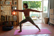 © Wavebreak Media - Caucasian woman in living room, practicing yoga, stretching