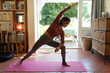© Wavebreak Media - Caucasian woman in living room, practicing yoga, stretching