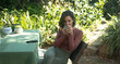 © Wavebreak Media - Caucasian woman in garden, sitting at table drinking coffee