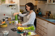 © Wavebreak Media - Caucasian woman standing in kitchen, preparing health drink