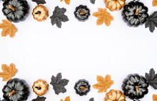 Banner. Modern Background With Autumn Leaves And Black, Golden Pumpkins On A White Background. Halloween With Copy Space For Text. Flat Lay, Top.