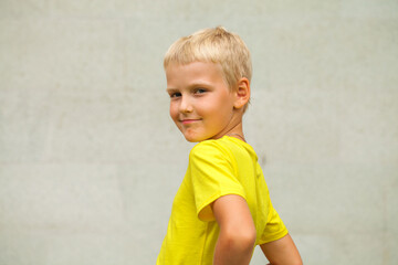 Blonde little boy in a summer park