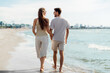 © Syda Productions - summer holidays and people concept - happy couple walking along beach in tallinn, estonia