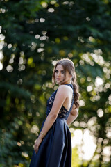 Poster - Shallow focus vertical shot of a young female looking at the camera in a blue dress