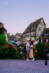 Wall Mural - Colmar, Alsace, France. Petite Venice, water canal, and traditional half timbered houses. Colmar is a charming town in Alsace, France. couple man and women walking at the street during vacation