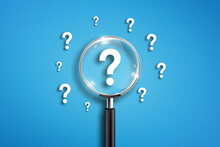 Magnifying Glass And Question Mark On Blue Background