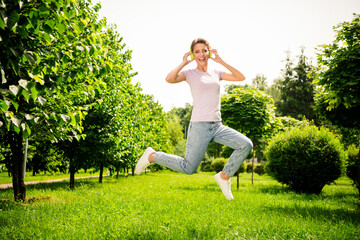 Poster - Full length body size view of attractive carefree cheerful girl jumping listening hit on fresh air outdoors