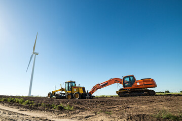 Wall Mural - Wind turbines and other heavy machinery